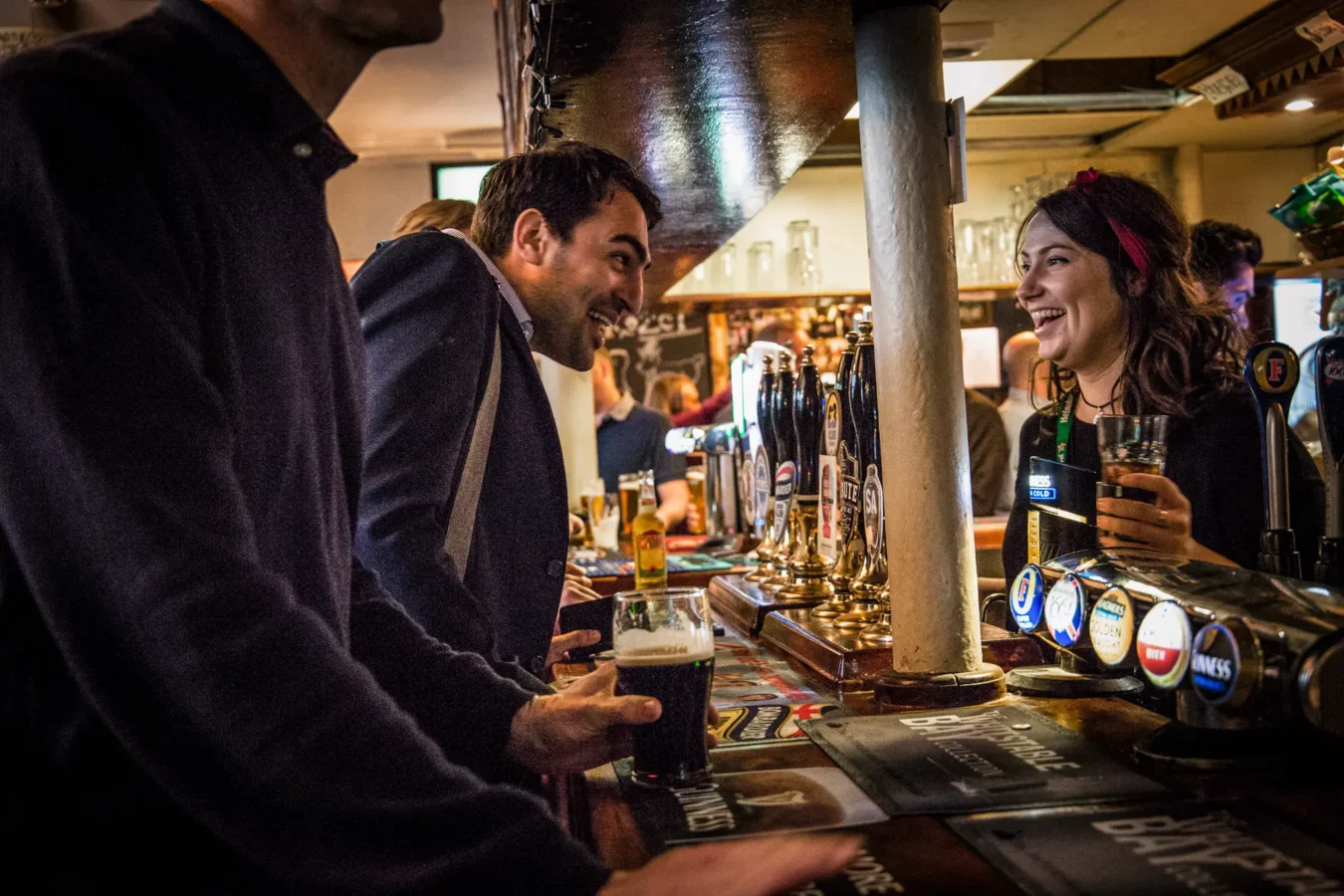 A bartender serving a pint at the bar of The Flying Horse pub on Wilson Street, EC2A, near Liverpool Street station