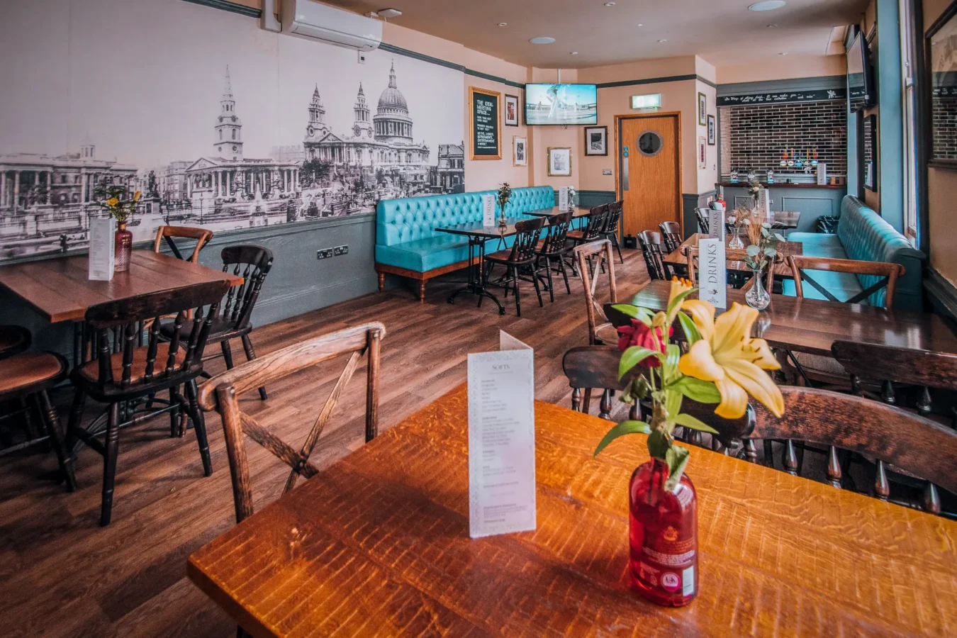 The upstairs function room at The Flying Horse pub on Wilson Street, EC2A, set up for a private event with HD screens