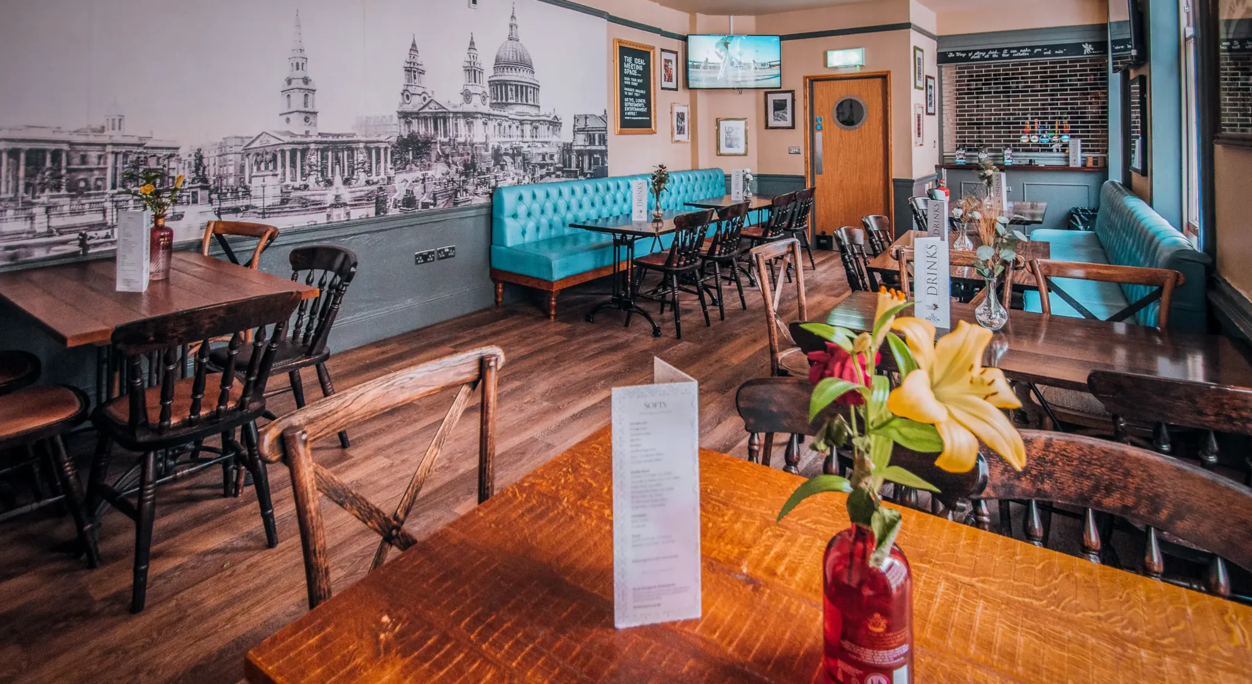 The upstairs function room at The Flying Horse pub on Wilson Street, EC2A, set up for a private event with HD screens