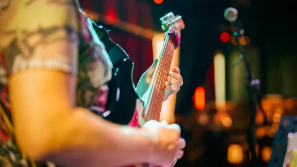 A guitarist performing live on stage at The Flying Horse pub on Wilson Street, EC2A, near Liverpool Street station