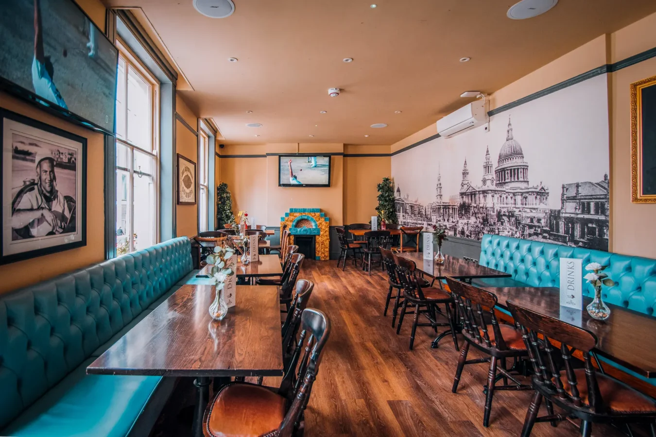 The private hire room at The Flying Horse pub near Moorgate and Liverpool Street, with banquette seating and HD screen