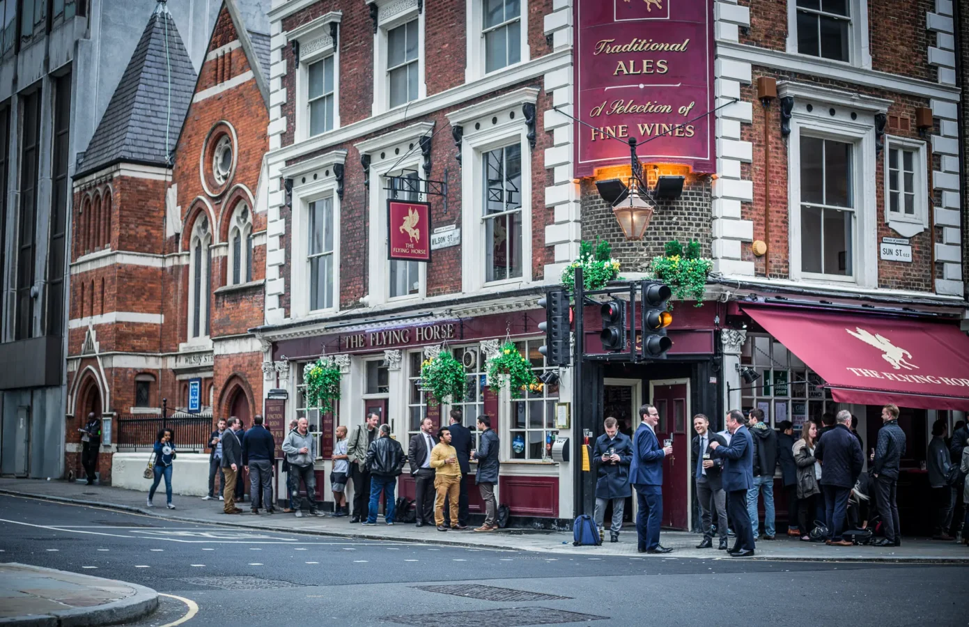 After-work drinkers outside The Flying Horse pub on Wilson Street, EC2A, between the City of London and Shoreditch