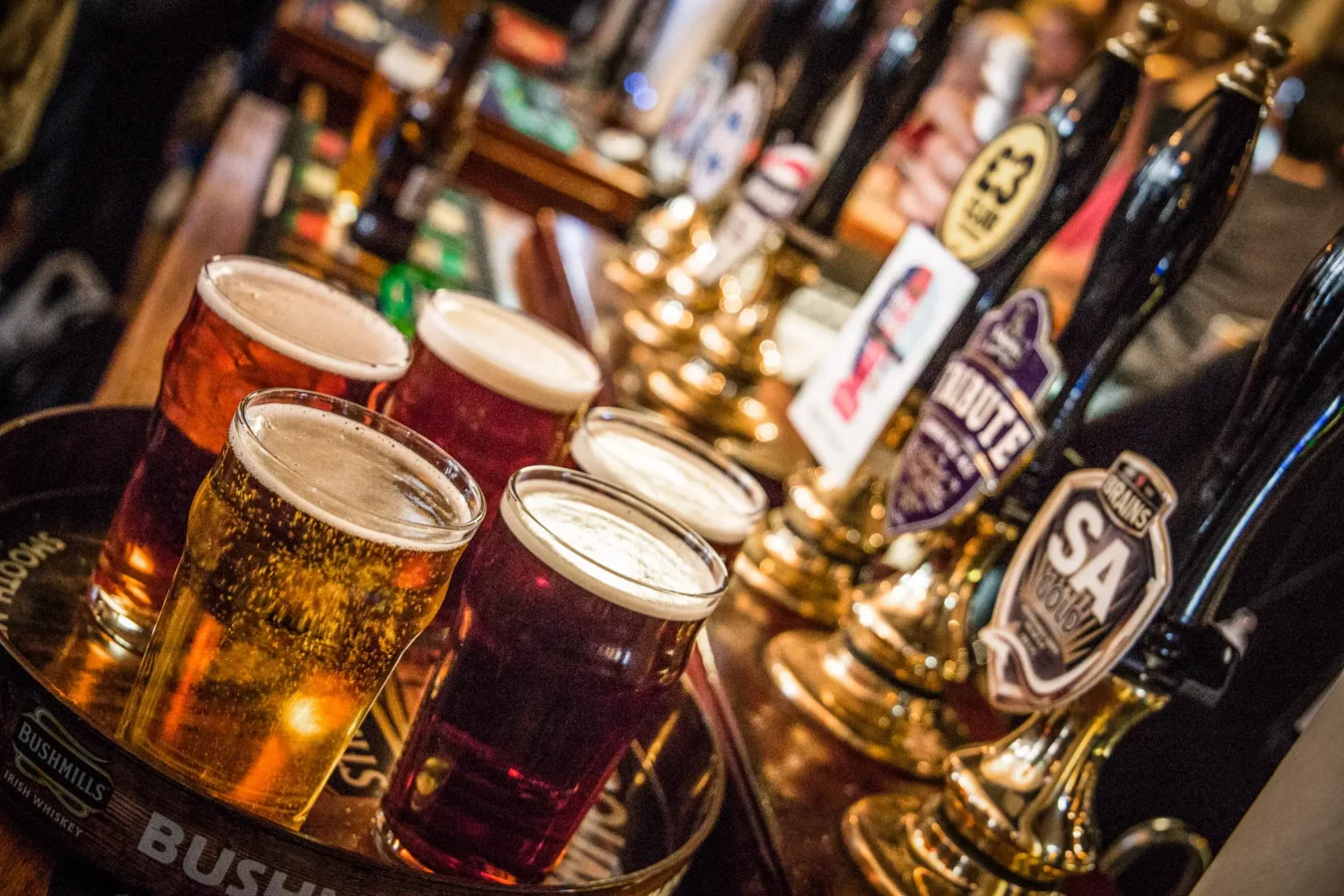 A tray of draught beers and cask ales on the bar at The Flying Horse pub, Wilson Street, EC2A
