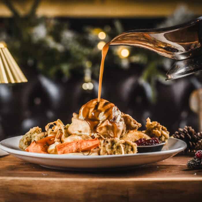 Festive dessert platter with ice cream, caramel sauce, and berries at The Flying Horse.