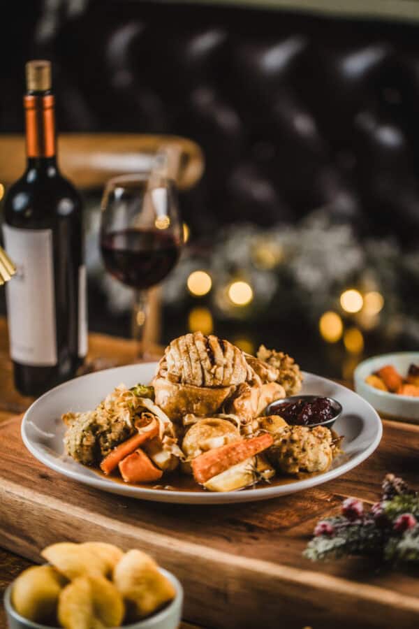 A hearty roast dinner with vegetables and gravy at The Flying Horse pub.
