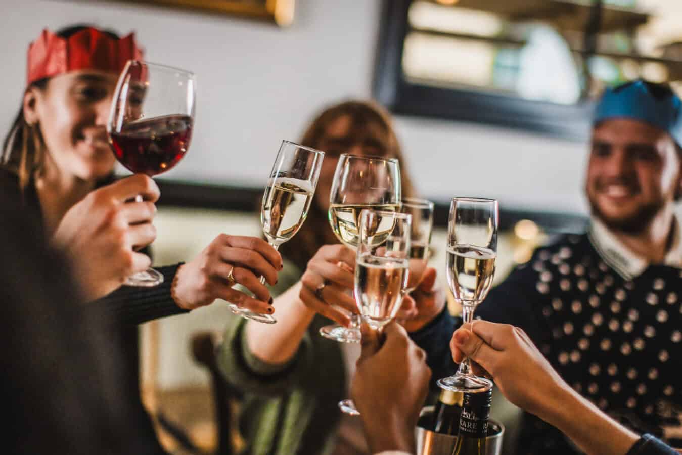 Group of friends celebrating with wine and champagne at The Flying Horse pub.