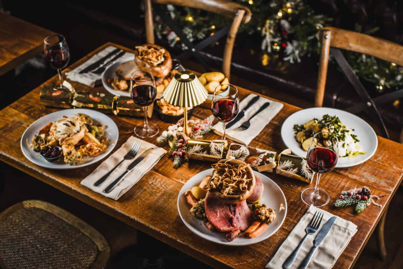 Christmas dinner setup with roast beef, wine, and festive decorations at The Flying Horse.