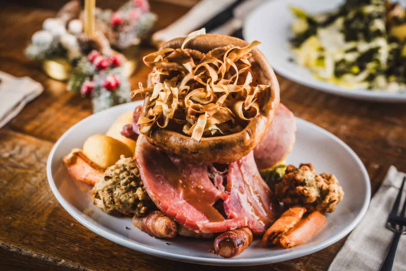Classic British roast dinner with meats, vegetables, and Yorkshire pudding at The Flying Horse.