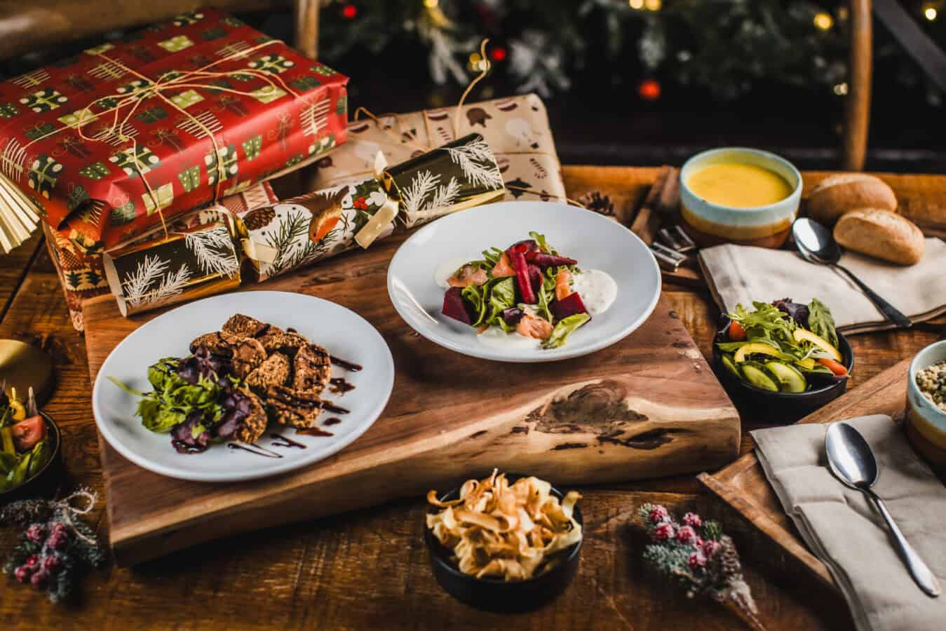 Christmas-themed meal with salads, bread, and desserts at The Flying Horse pub.