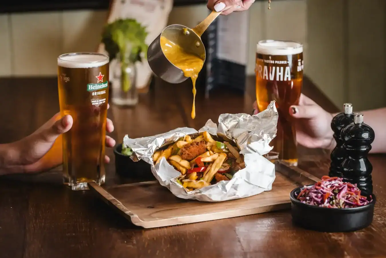 People enjoying beer and food at The Flying Horse pub.