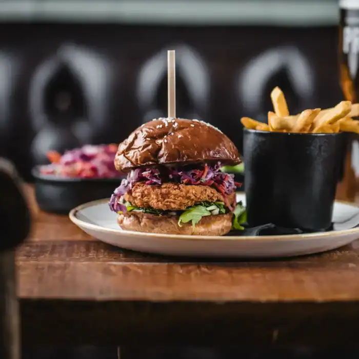 Delicious burger with fries and beer at The Flying Horse pub.