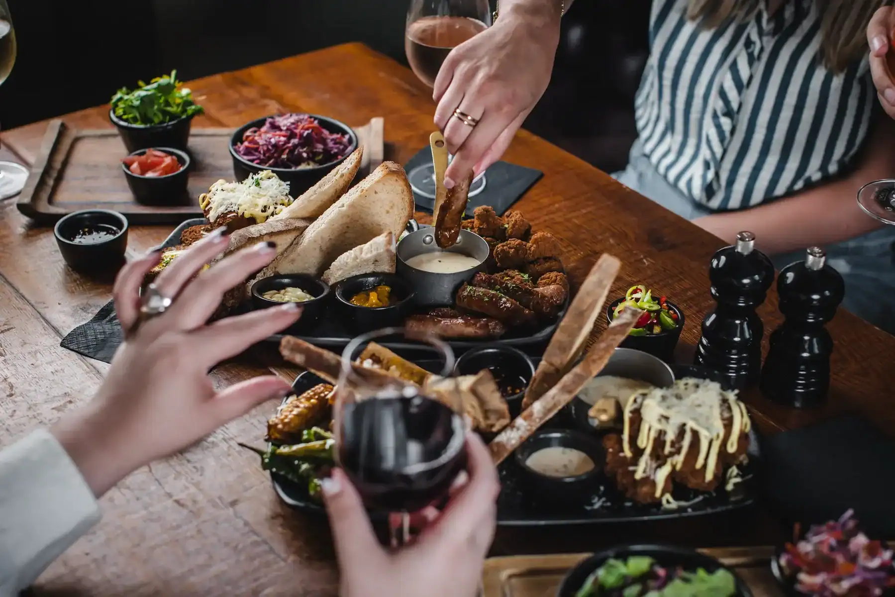 People enjoying a variety of pub food and drinks at The Flying Horse.