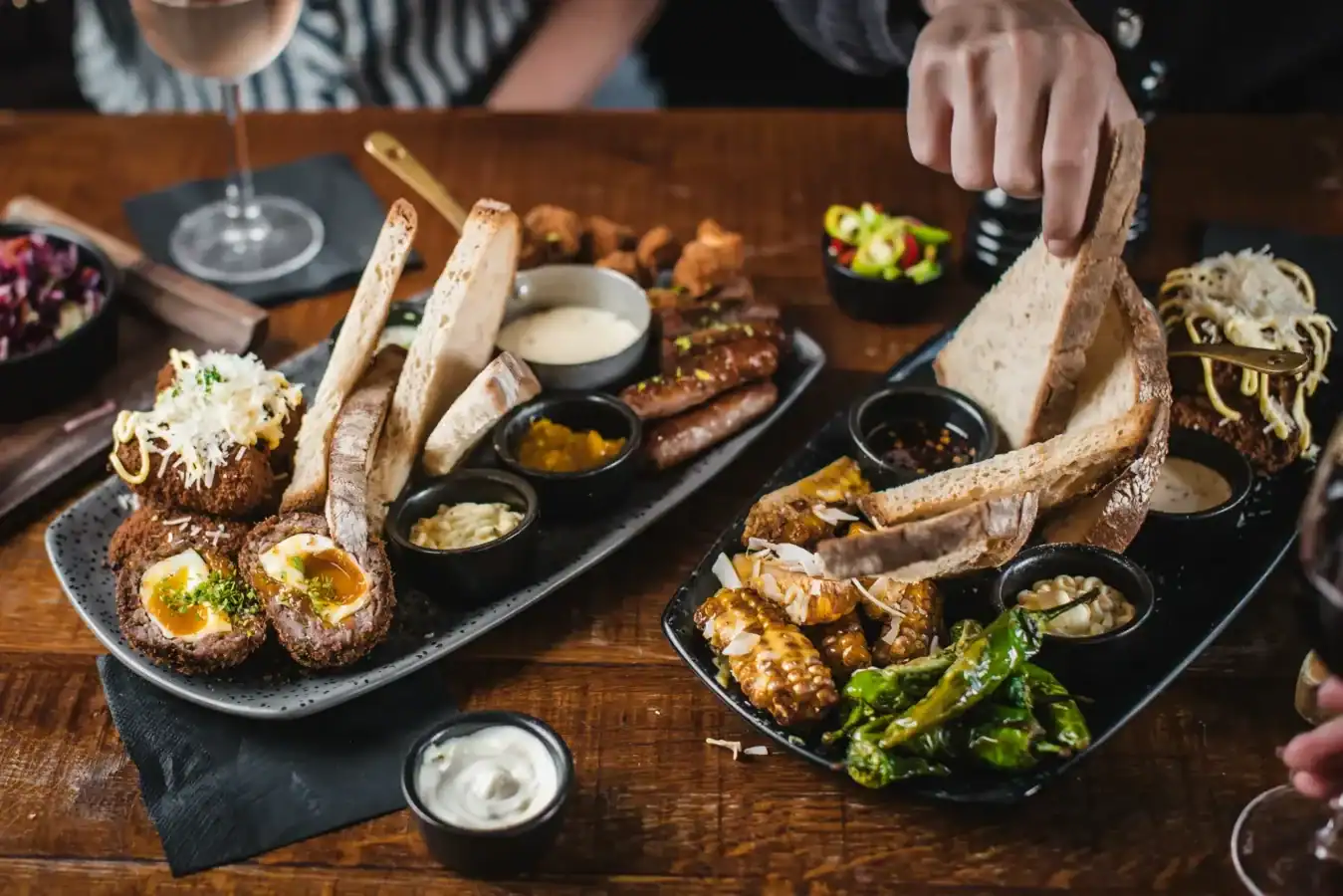 Variety of pub food including bread, dips, and cooked dishes at The Flying Horse.