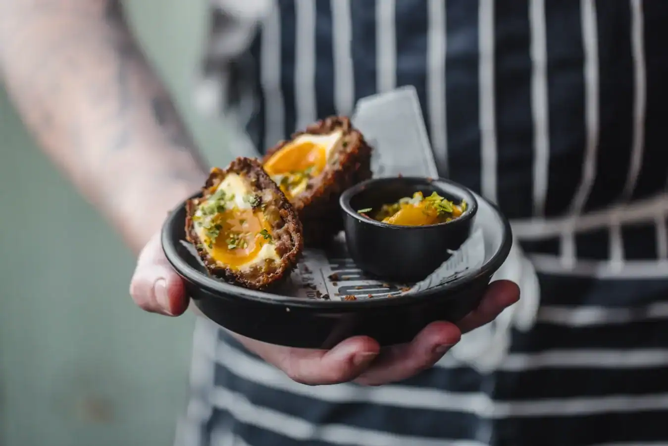 Gourmet Scotch Egg served with mustard and pickles at The Flying Horse pub.